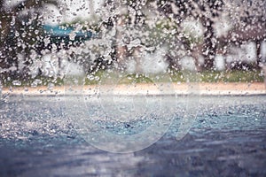 Vintage background with freezed water drops after splashing in swimming pool on water surface during rain with blurred backg