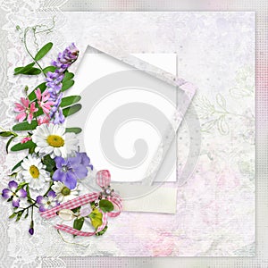 Vintage background with lace, frame for photo or text and a bouquet of summer meadow flowers