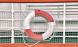 Vintage background with rescue circle on boat. Lifebuoy is mounted on a ship