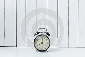 Vintage background with retro alarm clock on table