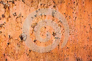 Vintage background of rusty metal sheet with exfoliated orange paint