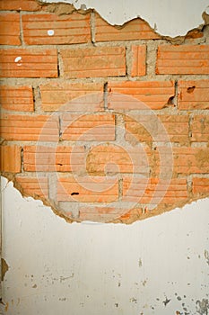 Vintage background texture old masonry stone bricks on the ancient cement with cracks. Fragment of old red brick wall with falling