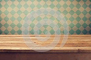 Vintage background with wooden deck table over retro wallpaper