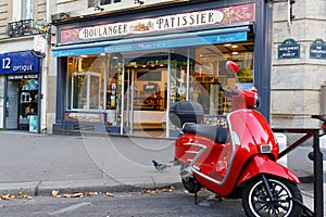 The vintage bakery and cake shop Marceaux and vintage scooter in the foreground . It located at Reuilly boulevard in