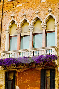 Vintage balcony with purple flowers