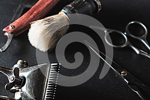 Vintage Barber shop equipment on Black background . Professional hairdressing tools. scissor, manual hairclipper, razor, shaving