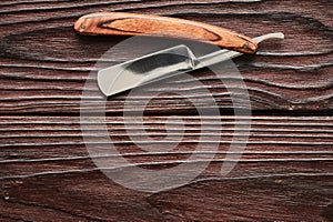 Vintage barber shop straight razor tool on wooden background