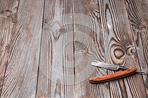 Vintage barber shop straight razor tool on wooden background