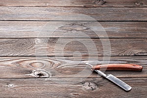 Vintage barber shop straight razor tool on wooden background