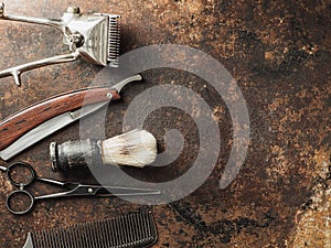 vintage barber tools: dangerous razor, hairdressing scissors, old manual clipper, comb, shaving brush