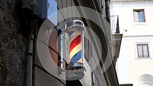 Vintage barbershop and hairdresser symbol. Traditional barber pole rotating in barbershop