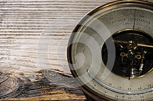 Vintage barometer on grunge wooden table