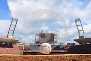 Vintage baseball ball on a home plate, in a sport stadium
