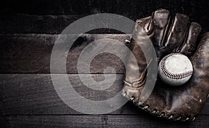 Vintage baseball gear on a wooden background