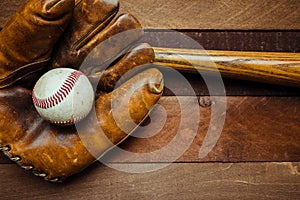 Vintage baseball gear on a wooden background