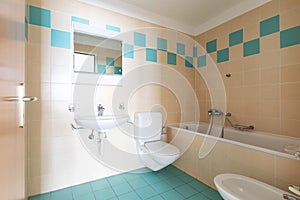 Vintage bathroom with beige and blue tiles