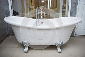 Vintage bathtub with faucet and shower in bathroom