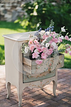 A vintage beige bedside table