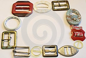 VINTAGE BELT BUCKLES ON OFF WHITE BACKGROUND