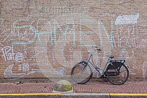 Vintage bicycle against grunge brick wall