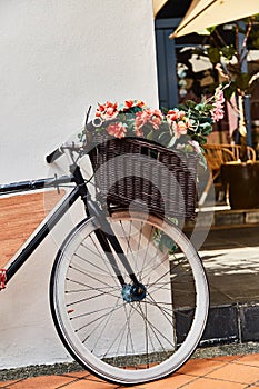 Vintage bicycle with basket against white wall background. Close-up