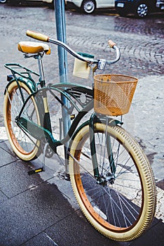 vintage bicycle with basket parked on street of