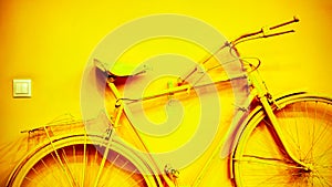 Vintage yellow bicycle on decorative house wall