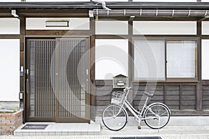 Vintage bicycle in front of old style house Japan.