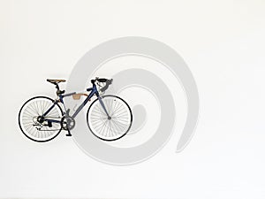 Vintage bicycle hanging on white wall for decoration