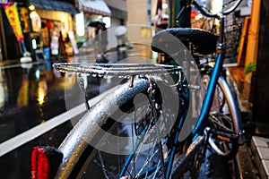 Vintage bicycle parking on retro road rainy day