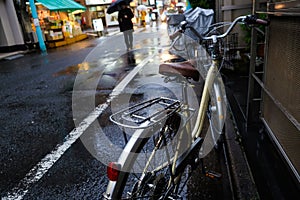 Vintage bicycle parking on retro road rainy day