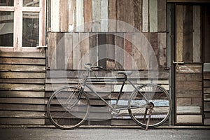 Vintage Bicycle standing near a vintage wood wall