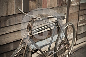 Vintage Bicycle standing near a vintage wood wall