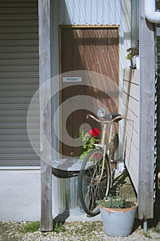 Vintage bicycle on vintage wooden house wall