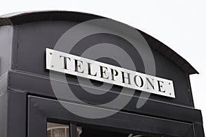 Vintage big black pay phone.