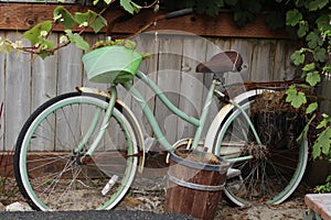 Vintage bike leaning up against a cedar fence