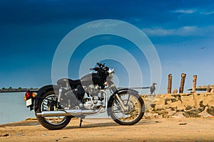 A vintage bike parked near a sea in india