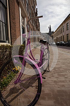 a vintage bike parked on a residential street in amsterdam