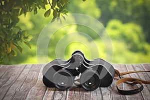 Vintage binoculars on wood table