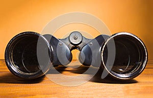 Vintage binoculars on wooden background