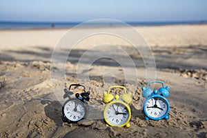 Vintage black alarm clock on autumn leaves. Time change abstract photo. Daylight saving time