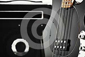 Vintage black electric bass guitar with an amplifier