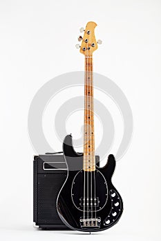 Vintage black electric bass guitar and amplifier
