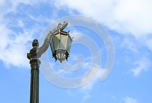 Vintage Black Lamppost Against Cloudy Blue Sky