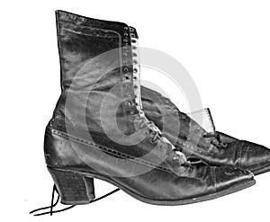 Vintage black leather boots on a white background