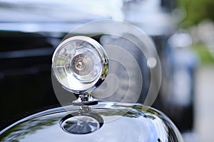 Vintage black Mercedes limousine signal light with chromium steel edges.