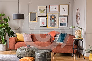 Vintage black poufs in trendy eclectic living room interior with brown couch