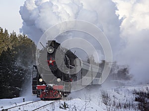 Vintage black steam locomotive in Russia in the winter