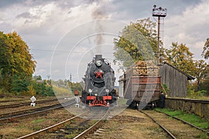 Vintage black steam locomotive train on railway station.