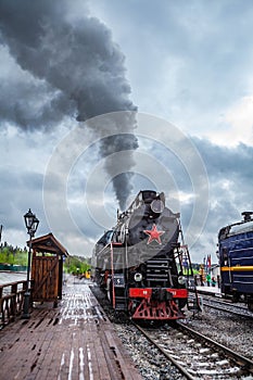 Vintage black steam locomotive train with wagons rush railway